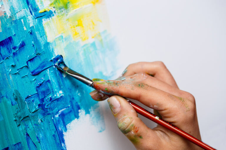 close-up-woman-drawing-with-oil-paints-canvas